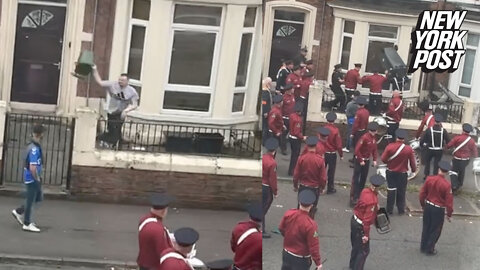Hilarious video shows marching band fight back after someone throws a garbage can at them