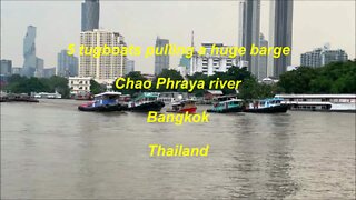 5 tugboats pulling a barge Chao Phraya river in Bangkok Thailand