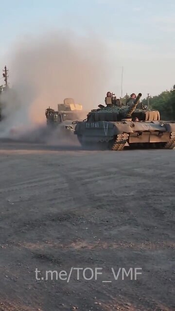 T-80BVM tank of the Russian Armed Forces towing the captured Ukrainian Husky TSV armored vehicle