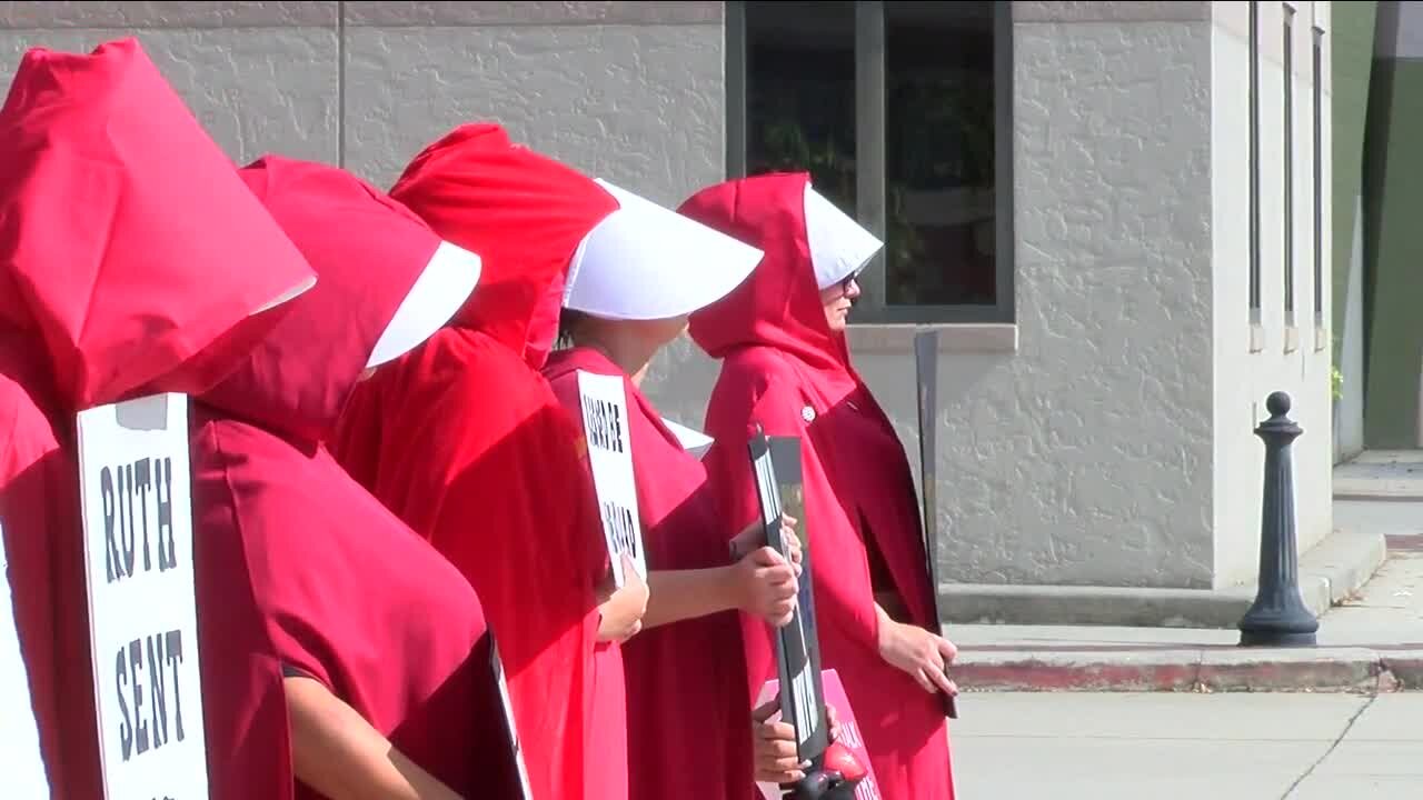 Southwest Florida Red Cloaks protesting on Dr. Martin Luther King Jr. Blvd.