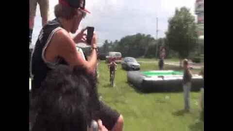 Teenager stupidly cycles into WOODEN finish line.