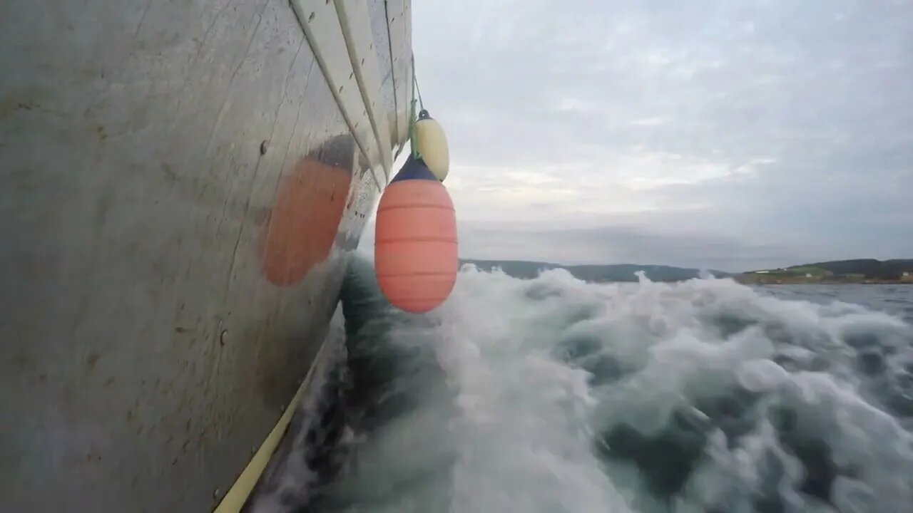 Low shot of professional fishing boat moving through ocean