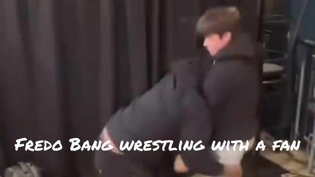 Fredo Bang wrestling with a fan