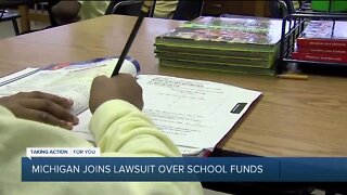 Michigan sues DeVos over order to give millions to private schools