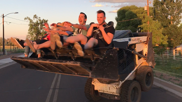 Crazy thrill ride in bucket of Bobcat loader
