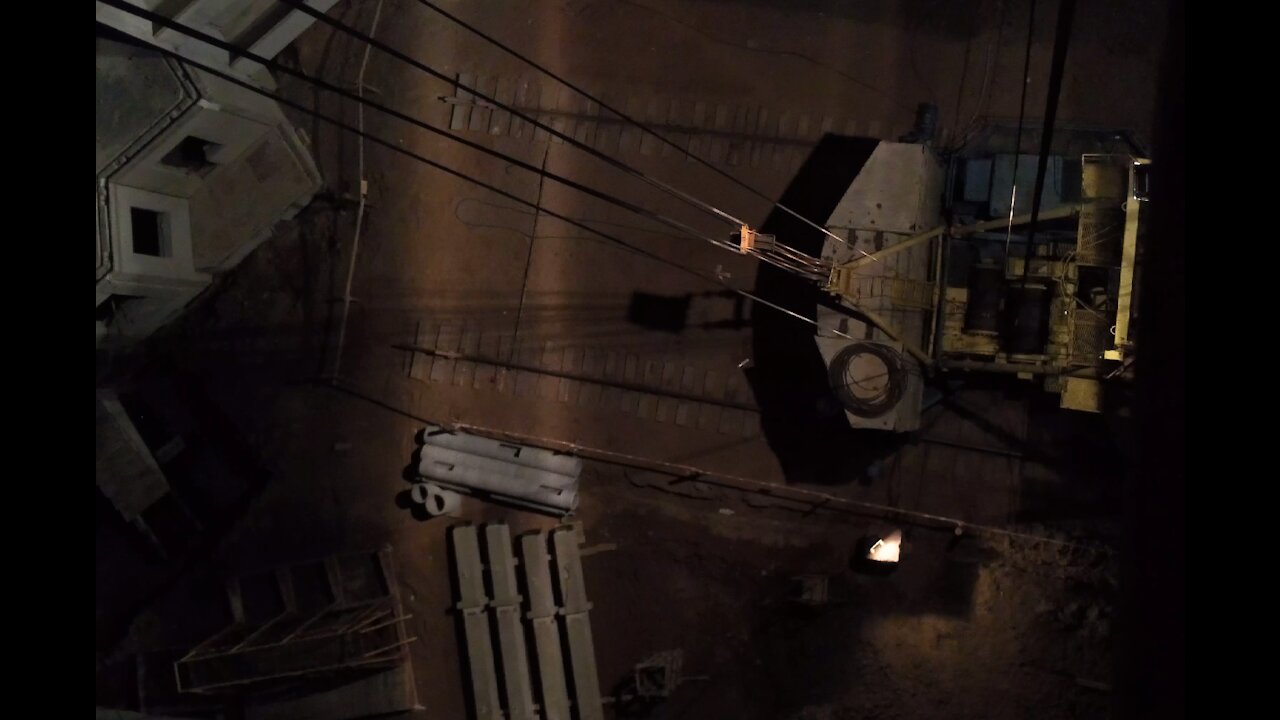 Falling bottles from the tap. At night on a tower crane.