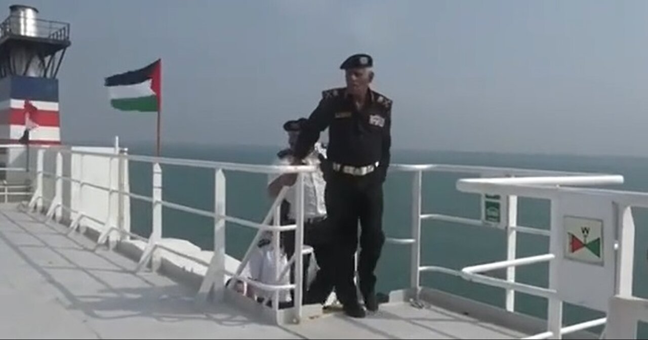 THE YEMENI NAVY COMMANDER EXAMINES THE CAPTURED CARGO SHIP "GALAXY LEADER" IN THE RED SEA