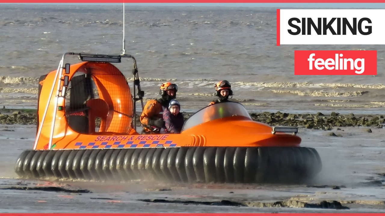 The moment boy, 7, is rescued after getting stuck in the mud on a beach