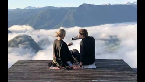 Couple has tea on top of a mountain