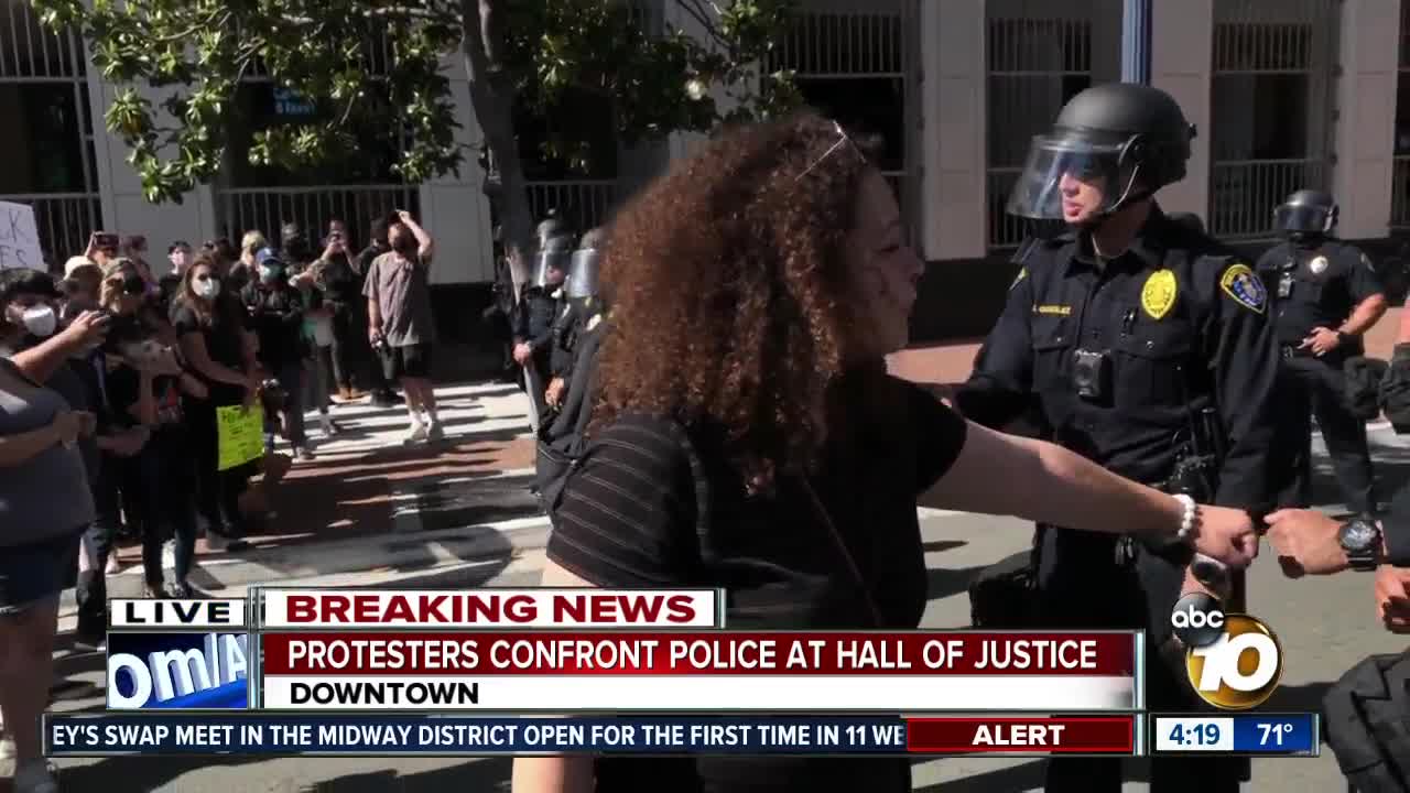 San Diegans peacefully protest, fist bump officers on the front lines