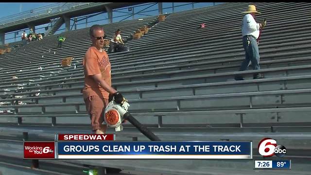 Volunteers help clean up stands at the Indianapolis Motor Speedway