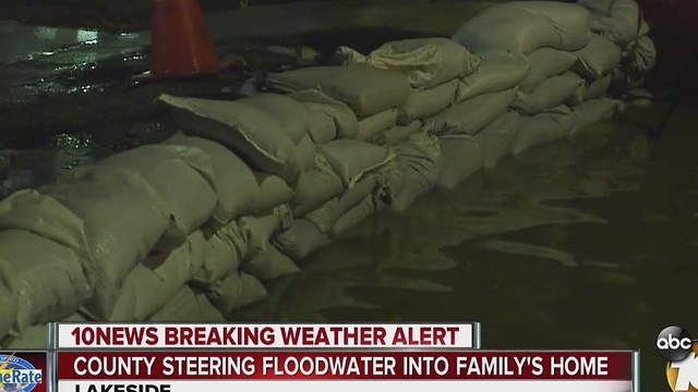 County steering floodwater into family's home