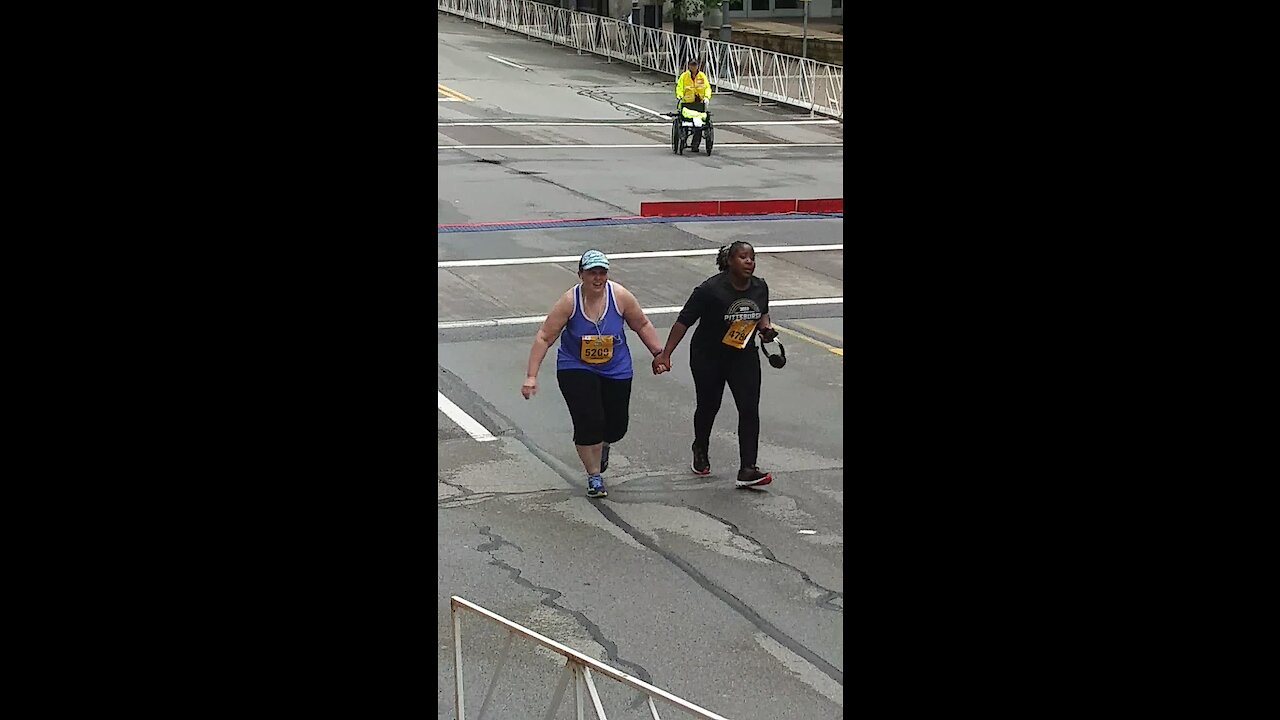 Two Final Runners Support Their Way To The Finish