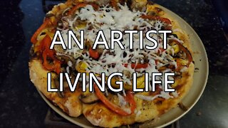 An artist living life baking pizzas in small oven