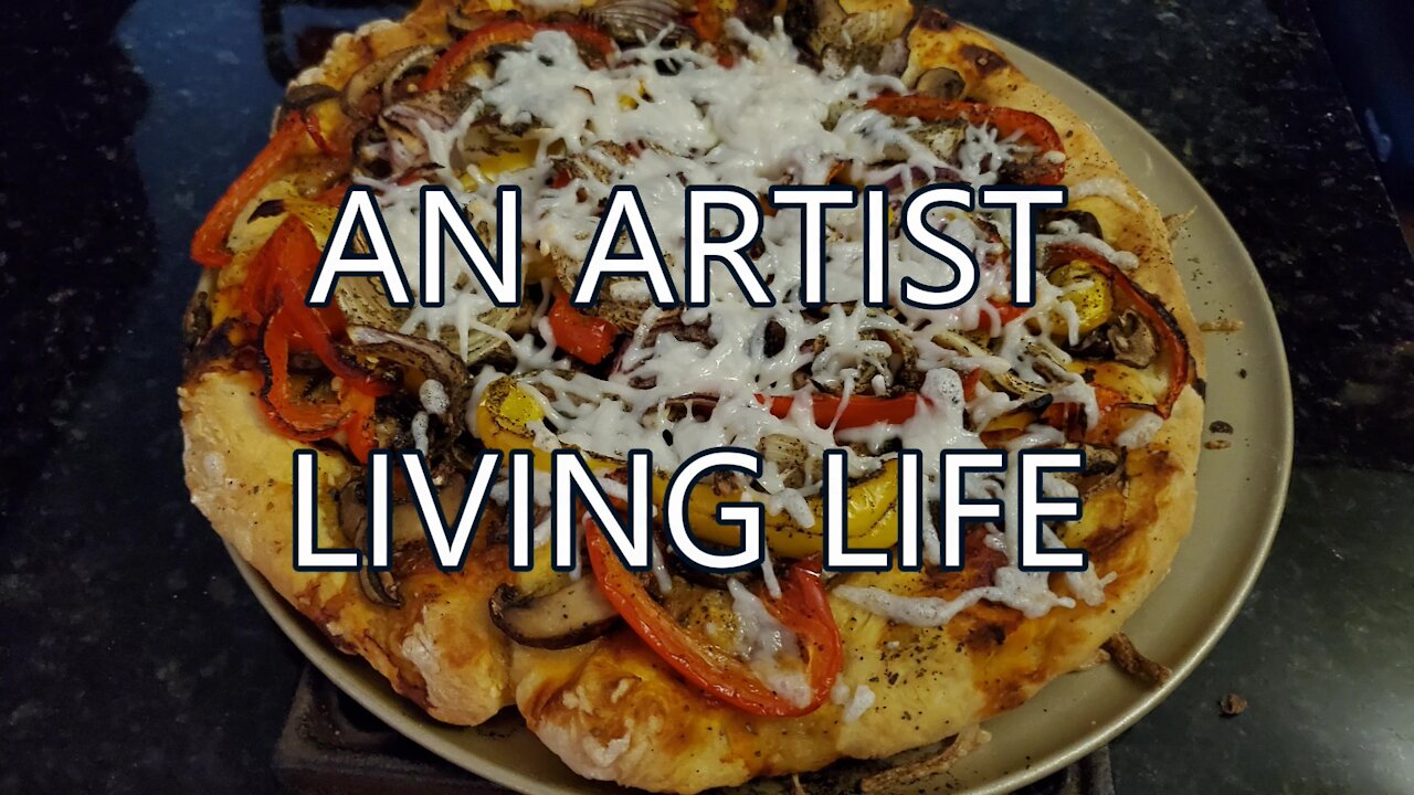 An artist living life baking pizzas in small oven