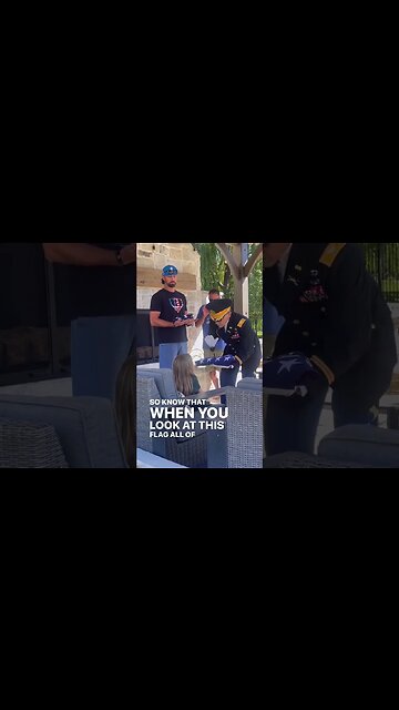 A Colonel presenting the flag to his grandnieces.