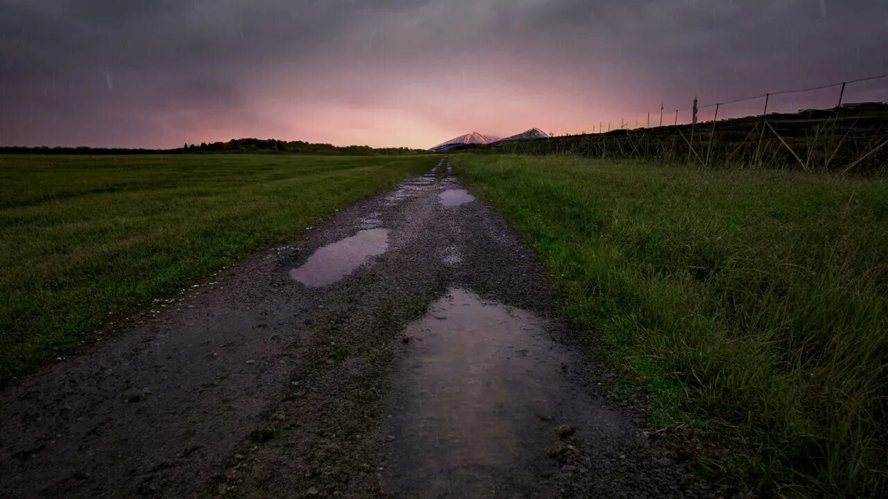 Evening rain on a gravel road near a field in the Vesterålen region of Norway