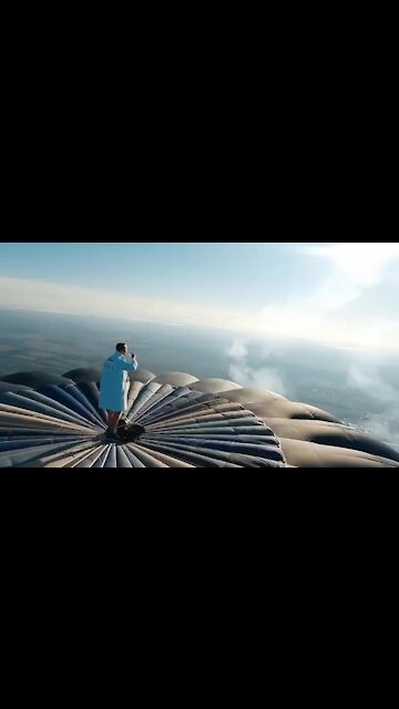This guy starts his day on top of a hot air balloon
