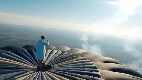 This guy starts his day on top of a hot air balloon