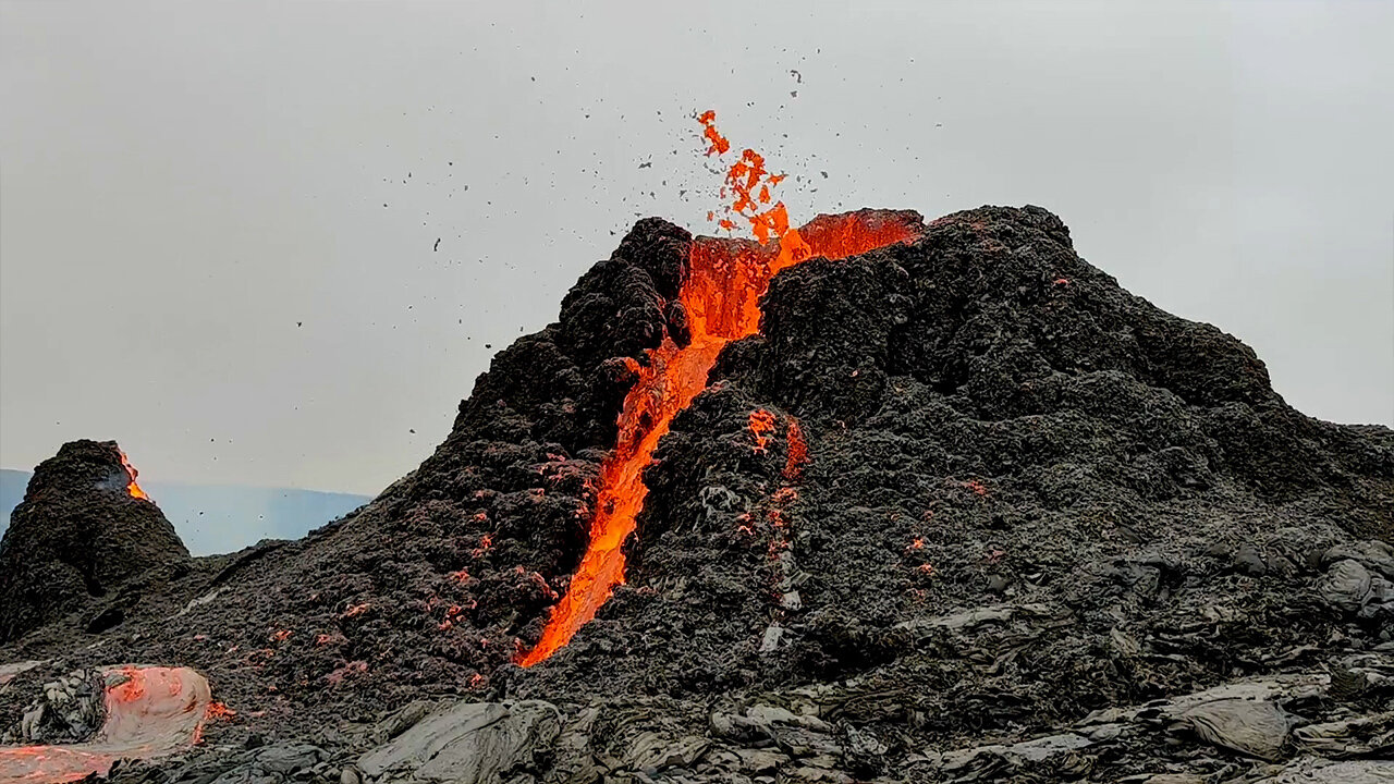 Iceland volcano erupts behind volleyball game