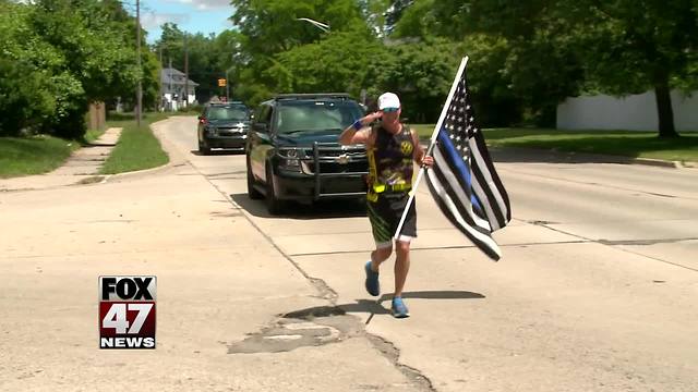 Police Officer running across the state