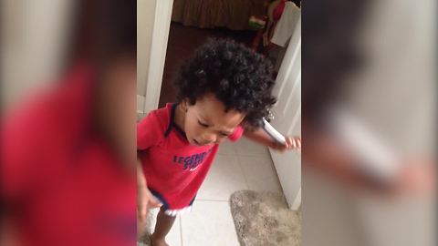 "A Tot Boy Tugs on A Comb After Getting It Stuck in His Hair"