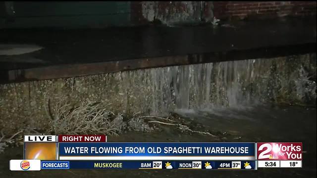 Water gushing out of old Spaghetti Warehouse and turning into ice