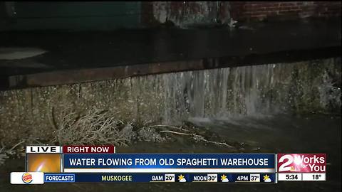 Water gushing out of old Spaghetti Warehouse and turning into ice