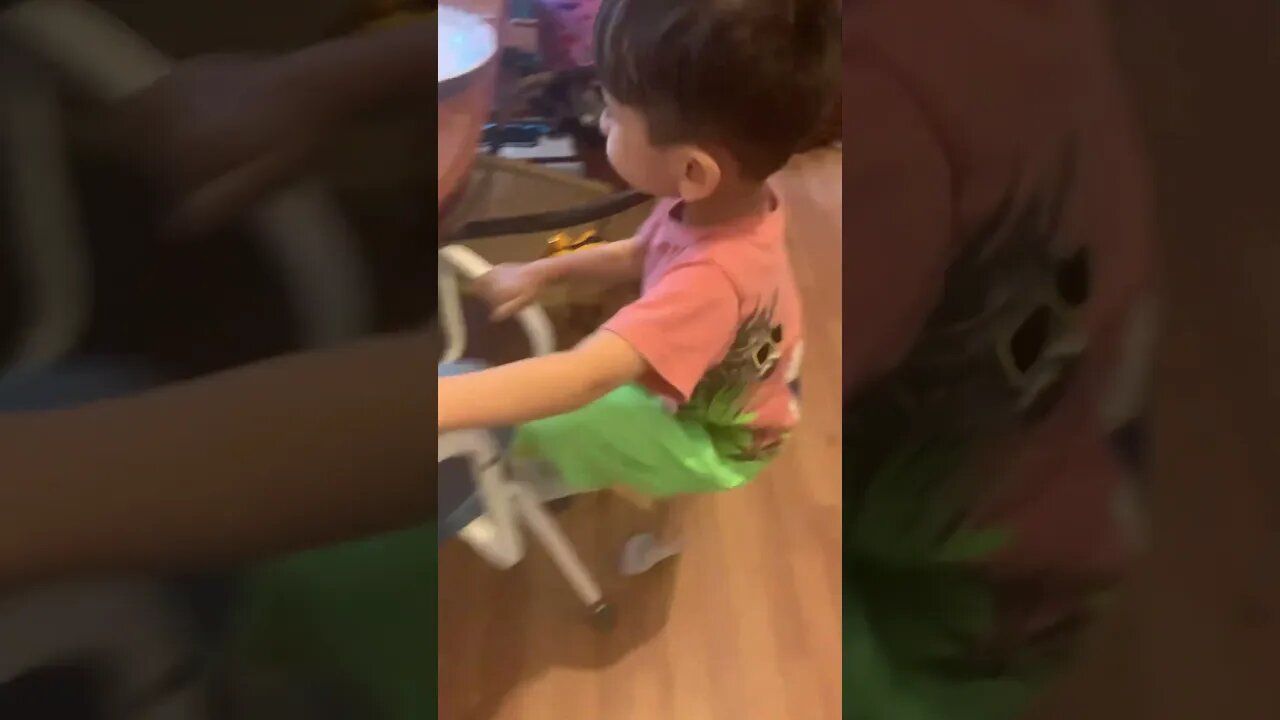 Little boy puts his toys on chair at the table so they can eat with us-cute