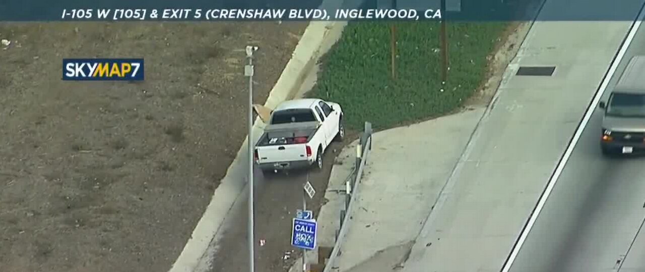 White pickup truck driving on shoulder in CA