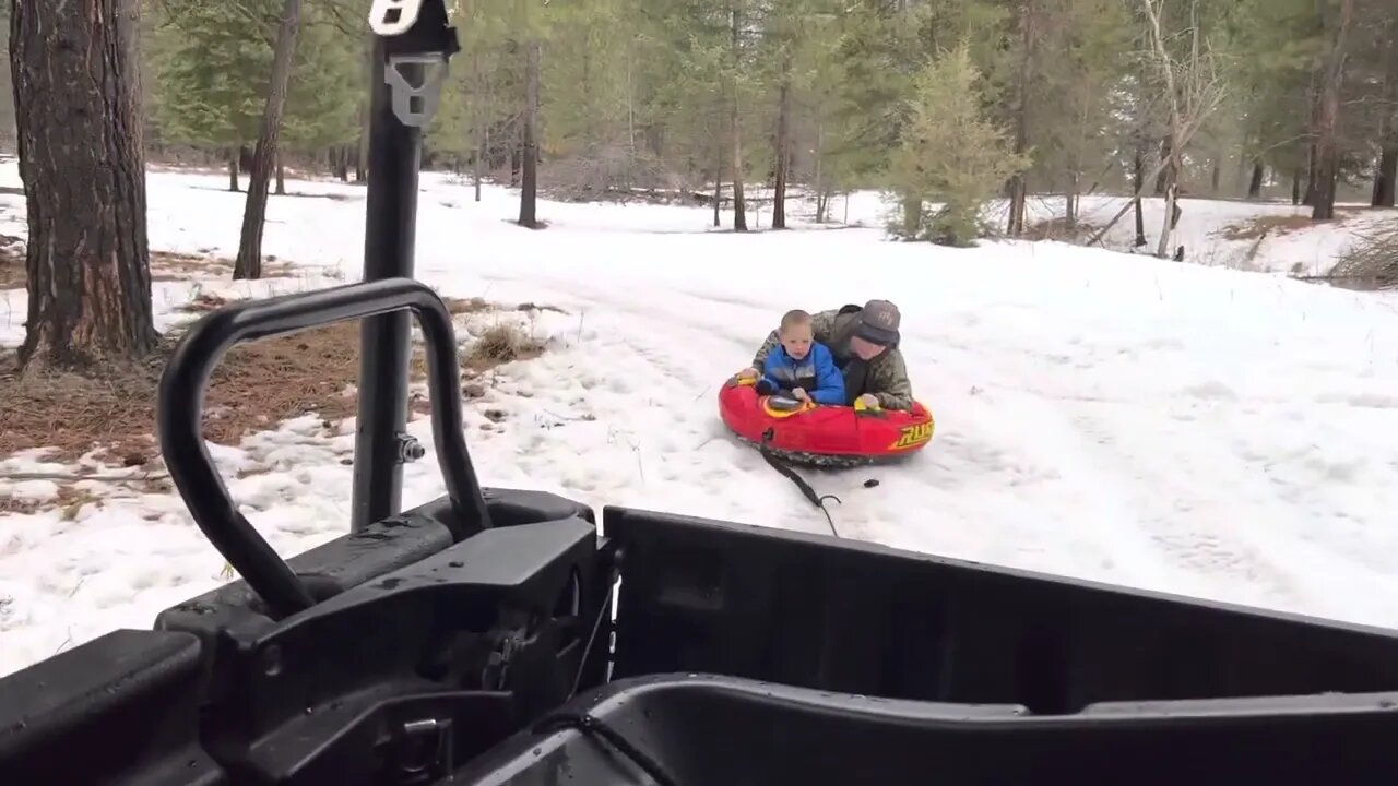 Scheels RUSH snow tube being pulled by atv on the farm.