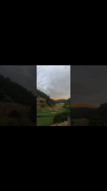 Sun hits the ridge under the stormy sky