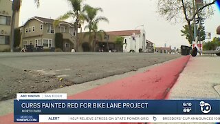 Curbs painted red in North Park for bike lane project