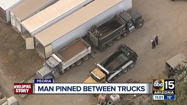 Man seriously hurt after being pinned between trucks at Peoria construction site