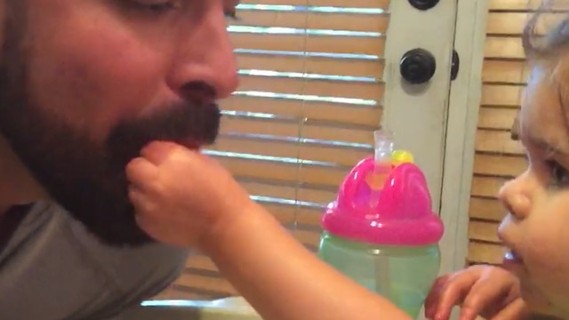 A Little Girl Feeds Her Dad While He Pretends To Be A Bird