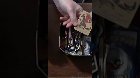 Pulling a bunch of gold Charizard cards out of a garage sale Pokémon tin