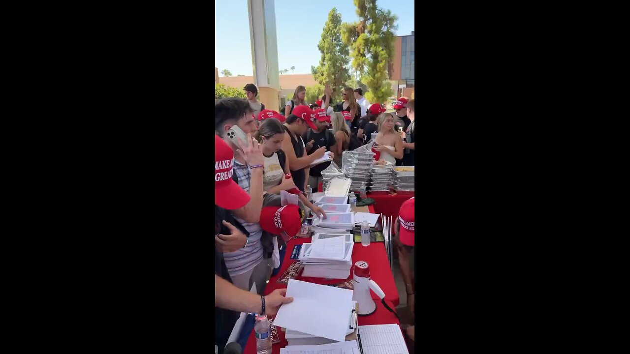 Students at ASU's "Greeks for Trump" event, handing out MAGA hats while pushing voter registration