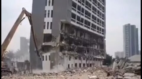 Excavator Destroying a building