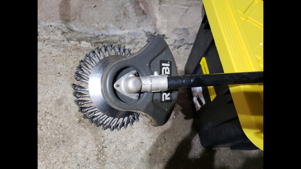 Weed wacker with wire brush wheel