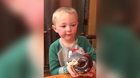 Little Boy Helps Himself To A Doughnut From A Cafe Counter