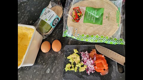 Breakfast with Avocado Eggs Red onion and Tomato in a Tortilla wrap