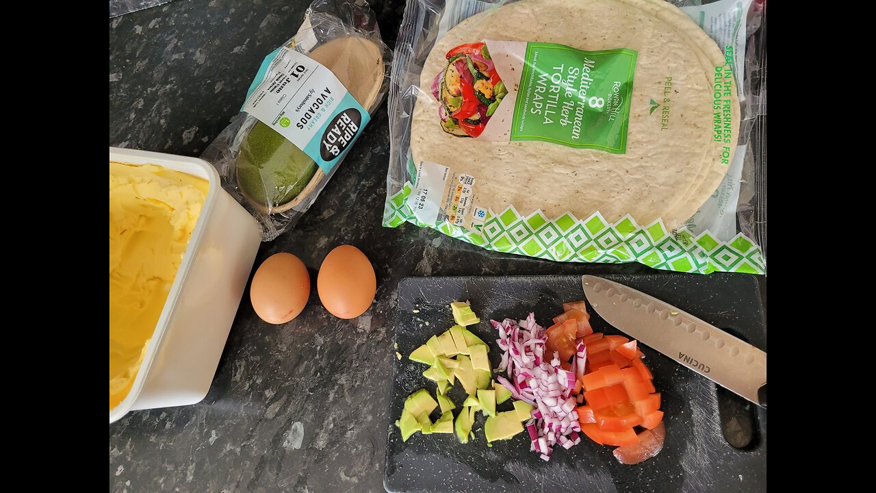 Breakfast with Avocado Eggs Red onion and Tomato in a Tortilla wrap
