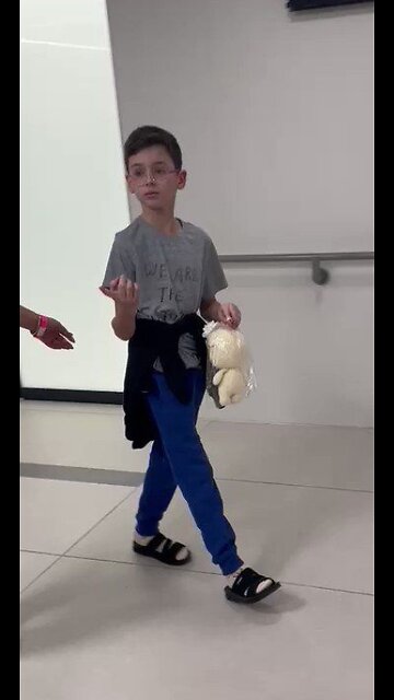 Ohad Munder (9), hugs his father for the first time after being released from captivity in Gaza.