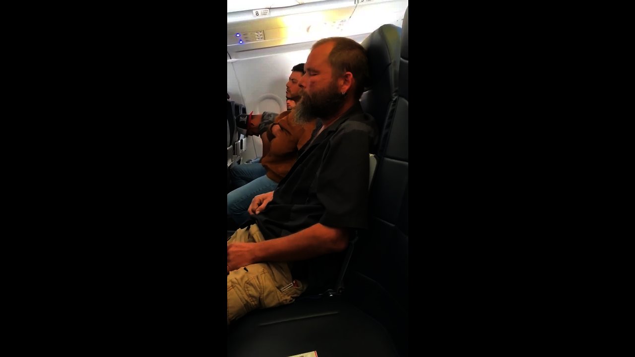 Sleepy Guy Forgets He Is On An Airplane And Lights A Cigarette