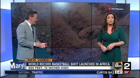 Men sink basketball shot from 660 feet high