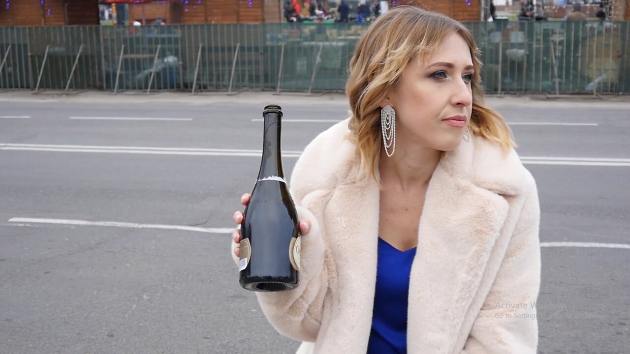 drunk-woman-on-a-street-drinks-wine-from-a-bottle-autumn-day