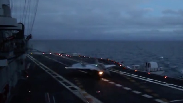 Naval fighter MiG-29K twilight landing to aircraft carrier