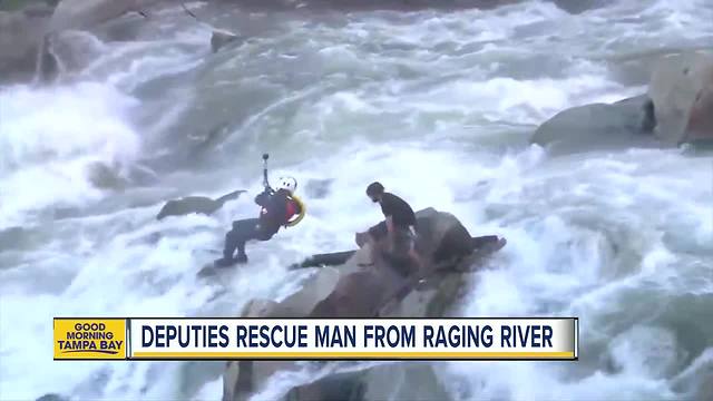 VIDEO: Deputies use a helicopter to rescue man stuck on a rock in raging river