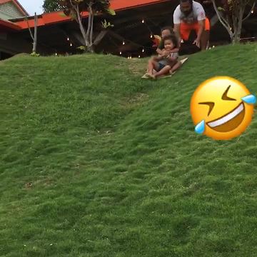 Two Tot Boys Try To Sled Down A Hill Off Grass