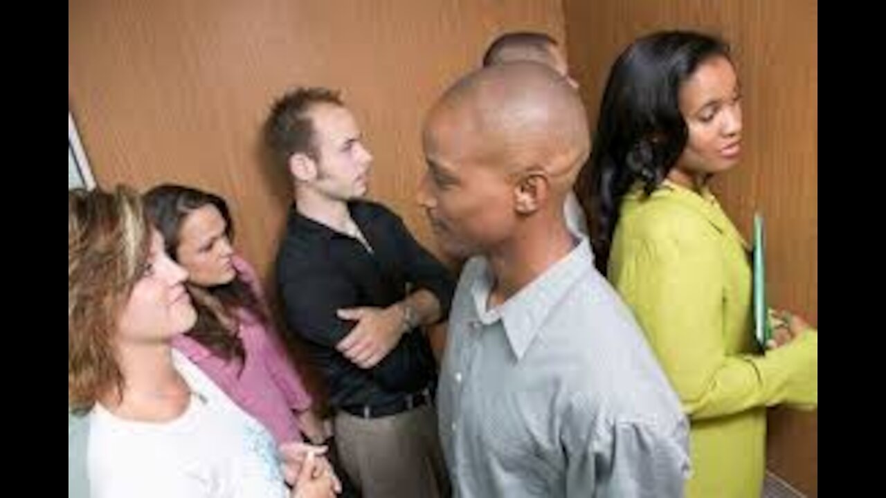 Woman Faces The Back Of An Elevator Simply Because Others Do It.